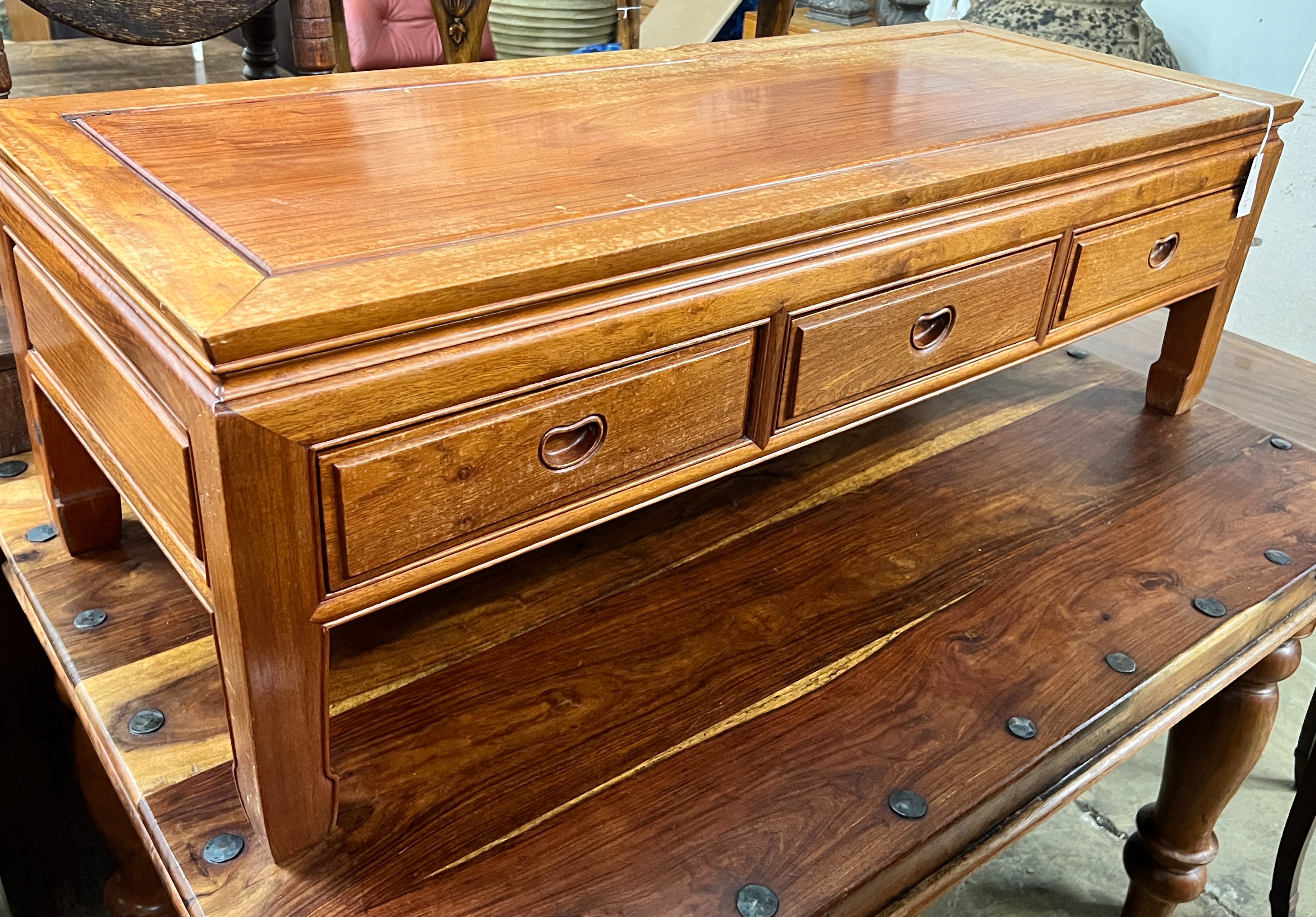 A Chinese rectangular hardwood three drawer coffee table, width 127cm, depth 50cm, height 40cm